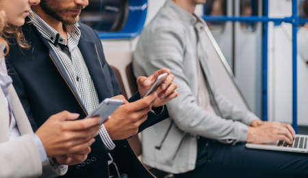 young couple communicates sitting in a subway car .の写真素材