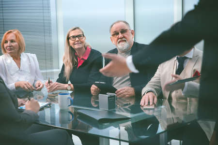 group of professionals listening to the report of the project Manager