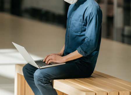 close up. male blogger with a laptop sitting on a bench.の写真素材