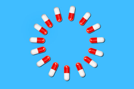 circle of medical capsules on a blue background.の写真素材