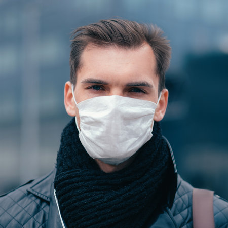 man in the protective mask is looking confidently aheadの写真素材