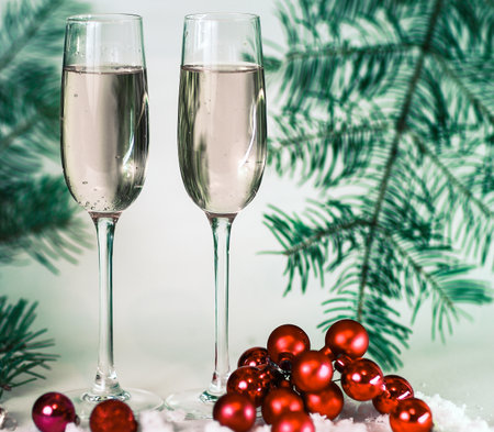 two glasses with champagne, and boxes with gifts on Christmasの写真素材