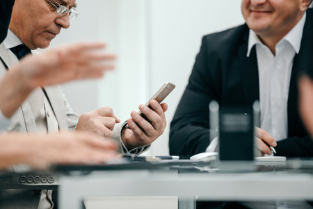 close up. businessman reading SMS on his smartphoneの写真素材