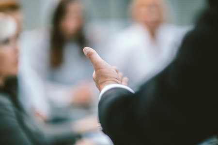 rear view. businessman reading a report at a working meeting.の写真素材
