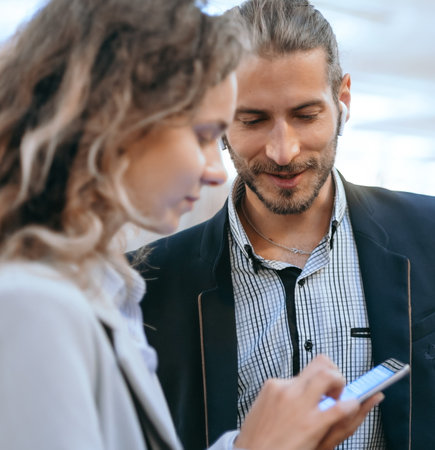 business colleagues discussing something in the subway.の写真素材