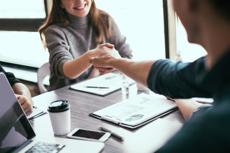 close up. business woman shaking hands with her financial partner .の写真素材