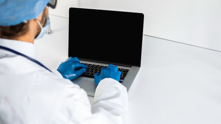 close up. doctor in protective gloves typing on a laptop .の写真素材