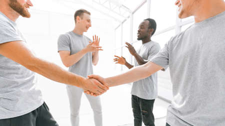 welcome handshake of friends in a bright office.の写真素材