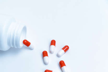 capsules with medicine and an empty bottle on a white background.の写真素材