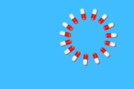 circle of medical capsules on a blue background.の写真素材