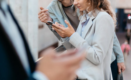 passengers using their smartphones while standing in the subway crossing.の写真素材