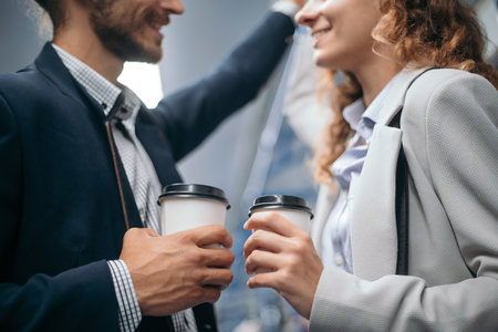 couple in love with a takeaway coffee while standing in a subway car.の写真素材
