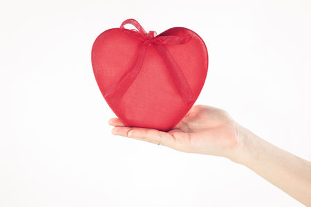 close up. a red heart in a womans hand.isolated on white backgroundの写真素材