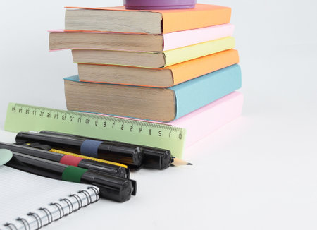 books and a variety of office supplies on white background .photの写真素材