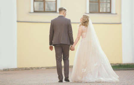 bride and groom walking down the street of the old town.の写真素材
