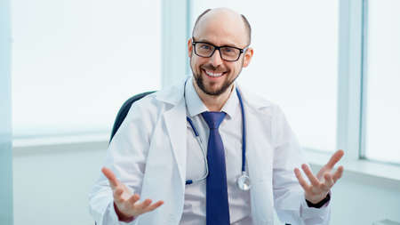 doctor conducts a consultation in his medical office.の写真素材
