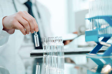 doctor takes an ampoule with the vaccine.