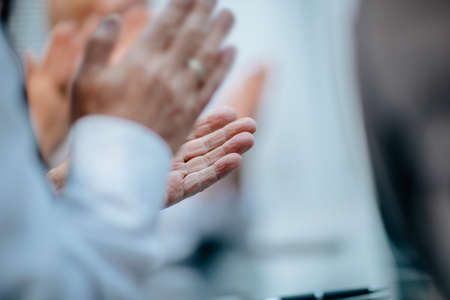 close up. group of business people applauding at a work meeting.