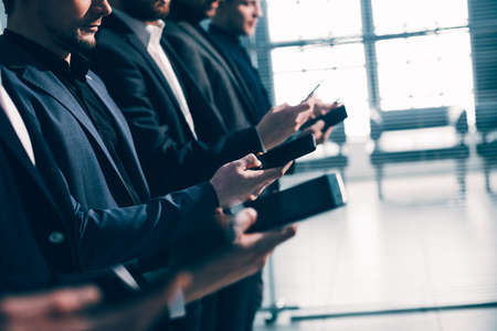 close up . image of a group of young business people with smartphonesの写真素材