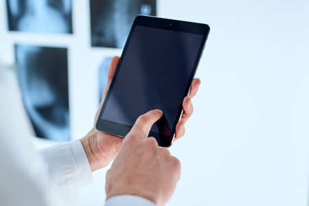 attending physician is using a digital tablet.の写真素材