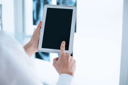 close-up. doctor is tapping on the screen of the digital tablet.の写真素材