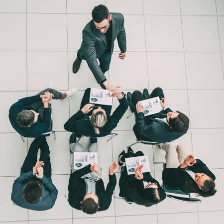 happy employees giving each other a high five at a work meeting.の写真素材