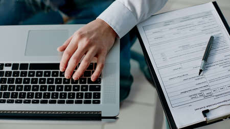business man uses a laptop to work with documents .