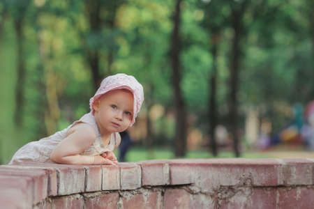 little girl standing near the city fountainの写真素材