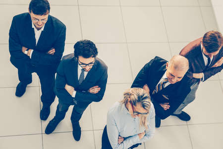 top view. confident business woman standing in front of her colleagues.の写真素材