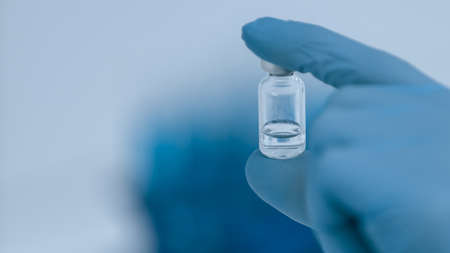 close up. vial with a vaccine in the hands of a scientist.の写真素材