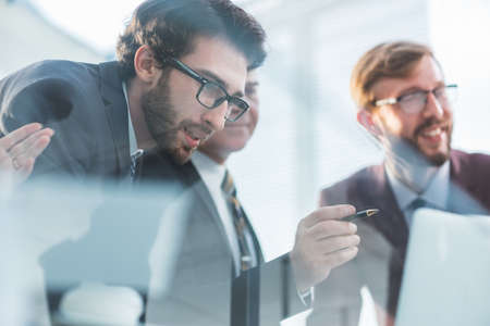 close up. working group looking at the monitors of office computers.の写真素材