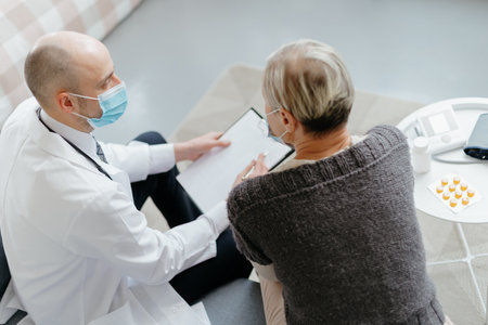 doctor and patient reading health insurance terms and conditions.の写真素材