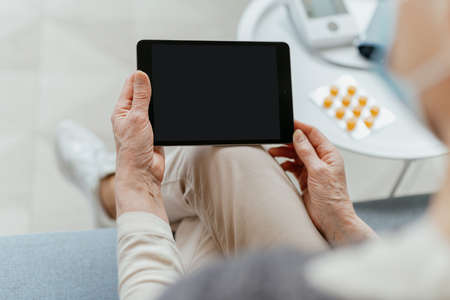 woman with a digital tablet sitting in a medical office.