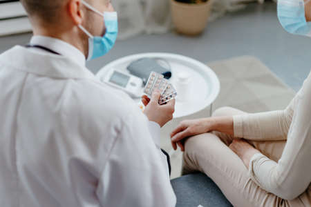 Doctor explaining medicine dosage to senior patient.