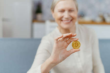 attractive lady looking at bitcoin in her hands.