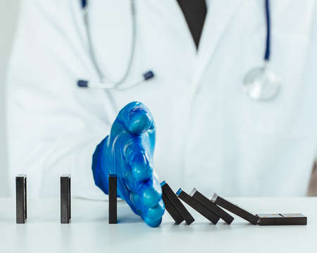 close up. virologist using dominoes to show a safe distance .の写真素材