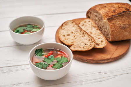 Wholegrain bread and a bowl of soupの写真素材
