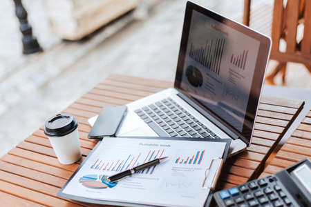 close up. pen and financial chart on the table in the cafe .の写真素材
