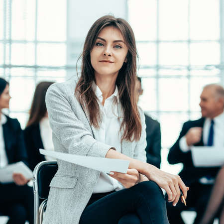 young business woman against the background of her colleagues.の写真素材