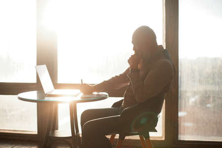 brooding business man works on a laptop .の写真素材