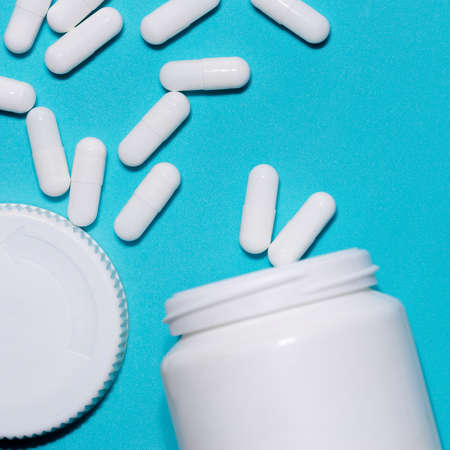 capsules with medicine on a blue background .の写真素材