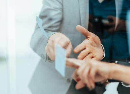 close up. employees discussing a sticky note on the glassの写真素材