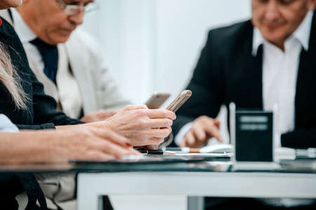 close up. businessman reading SMS on his smartphoneの写真素材