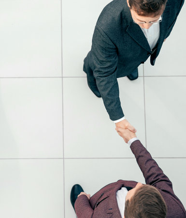 top view. business people meeting each other with a handshake.の写真素材