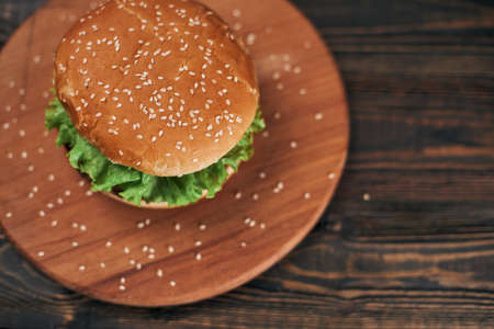 delicious burger on a wooden chopping board.の写真素材