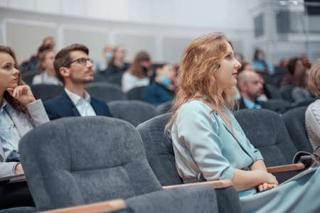 young business woman listening attentively to the speaker.の写真素材