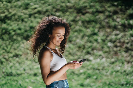 sporty young woman with a smartphone . close-up.