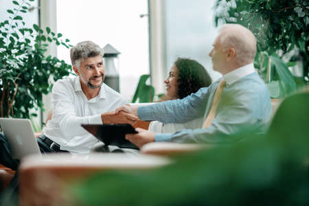 business partners completing the transaction a strong handshake .の写真素材