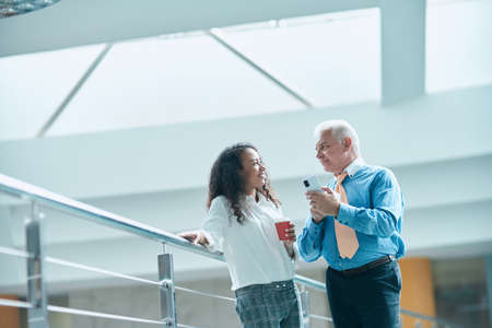 business colleagues reading the news on the smartphone screen.の写真素材