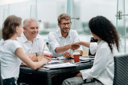 young business people shaking hands at a meeting in a business center.の写真素材